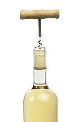 Image showing A bottle of white wine and a corkscrew