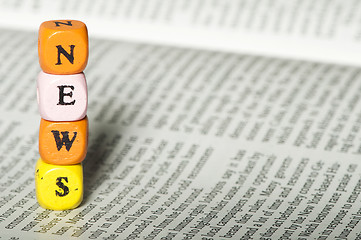 Image showing Word news.Wooden cubes on magazine