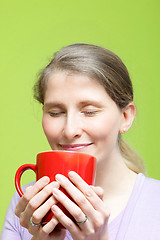 Image showing Woman savouring a mug of hot coffee