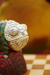 Image showing Figurine of chameleon on a chess-board.