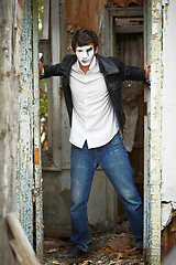 Image showing Guy mime against the old wooden door.