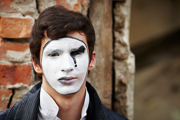 Image showing Guy mime against an old brick wall.