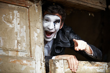 Image showing Guy mime against the old wooden door.