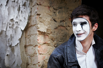 Image showing Guy mime against an old brick wall.