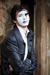 Image showing Guy mime against an old brick wall.