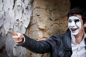 Image showing Guy mime against an old brick wall.