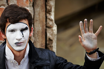 Image showing Guy mime against an old brick wall.