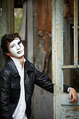 Image showing Guy mime against the old wooden door.