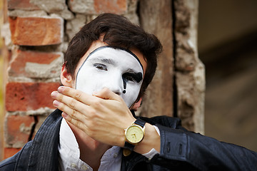 Image showing Guy mime against an old brick wall.