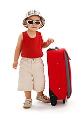 Image showing Little boy standing near luggage, ready for journey