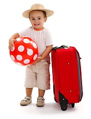 Image showing Kid with red ball and suitcase, ready for journey