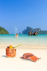 Image showing Coconut cocktail and young female model on the beach