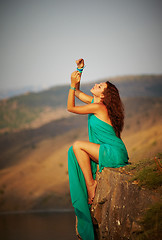 Image showing Girl sitting on the edge of a cliff.