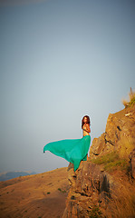 Image showing Beautiful girl standing on a precipice.