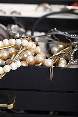 Image showing Pearls and jewellery overflowing from a box