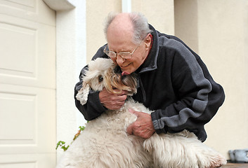 Image showing Happy senior man and his dog