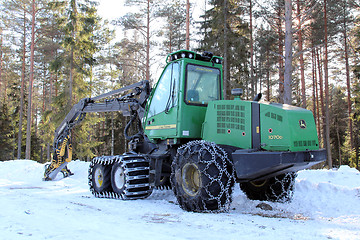 Image showing Green Wheeled Harvester by Forest Logging Site