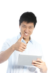 Image showing Smiling Asian man giving a thumbs up