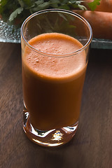 Image showing carrot juice on a wooden background 