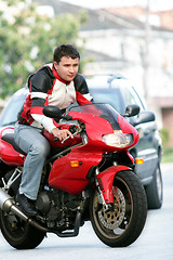 Image showing Man on a red bike