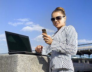 Image showing woman with mobile telephone and laptop