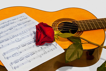 Image showing A guitar and a rose.