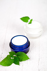 Image showing face cream in jars with urtica leaves