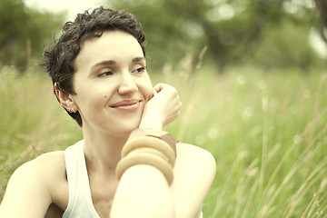 Image showing cute girl on green field 