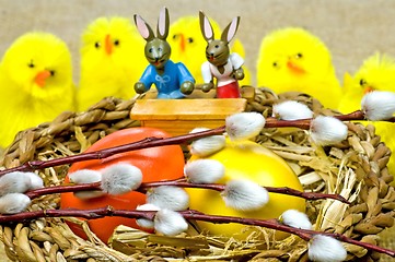 Image showing easter basket with painted eggs, catkin, biddies and bunnies