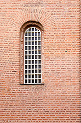 Image showing A window and a texture of a wall with red bricks