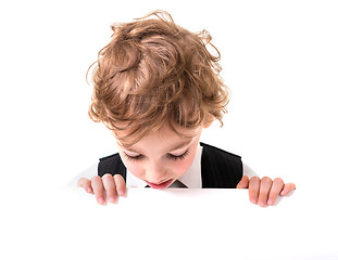 Image showing Little boy is peeking from blank sign