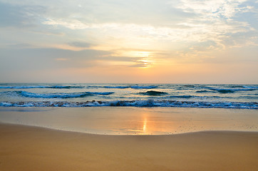 Image showing meditation in front of ocean waves and the low sun