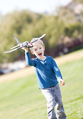 Image showing child playing with a plane