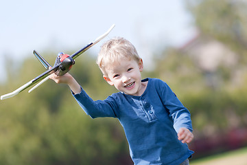 Image showing child playing with a plane