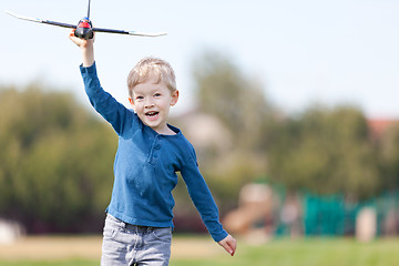 Image showing child playing with a plane