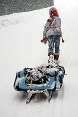 Image showing little girl dragging big sled