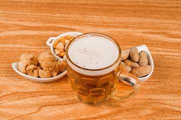 Image showing Tankard of beer and snacks
