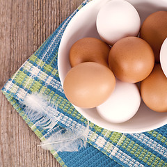 Image showing eggs in a bowl, towel and feathers