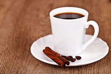 Image showing cup of coffee and cinnamon