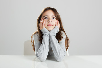 Image showing Little girl in a desk