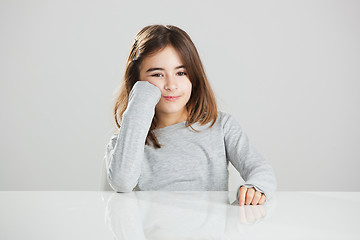 Image showing Little girl in a desk