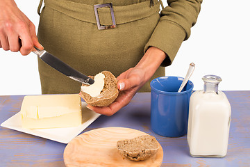 Image showing Buttering bread