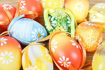 Image showing Bright color easter eggs with bows