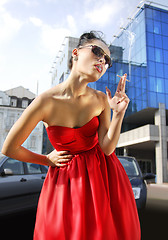 Image showing smoking lady in red dress