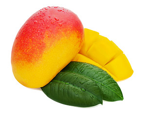 Image showing Fresh mango fruit with cut and green leaves isolated on white ba