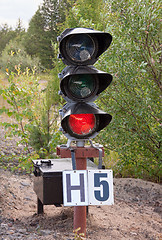 Image showing Traffic light shows red signal on railway. Railway station.