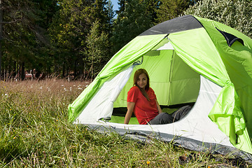 Image showing girl in a red dress in a tent in a forest