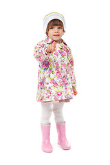 Image showing little girl in boots and a jacket shows finger