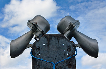 Image showing Outdoor public address loudspeakers against a blue sky