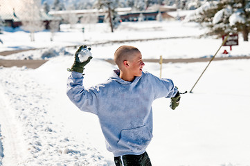 Image showing Bald boy throwing snowball